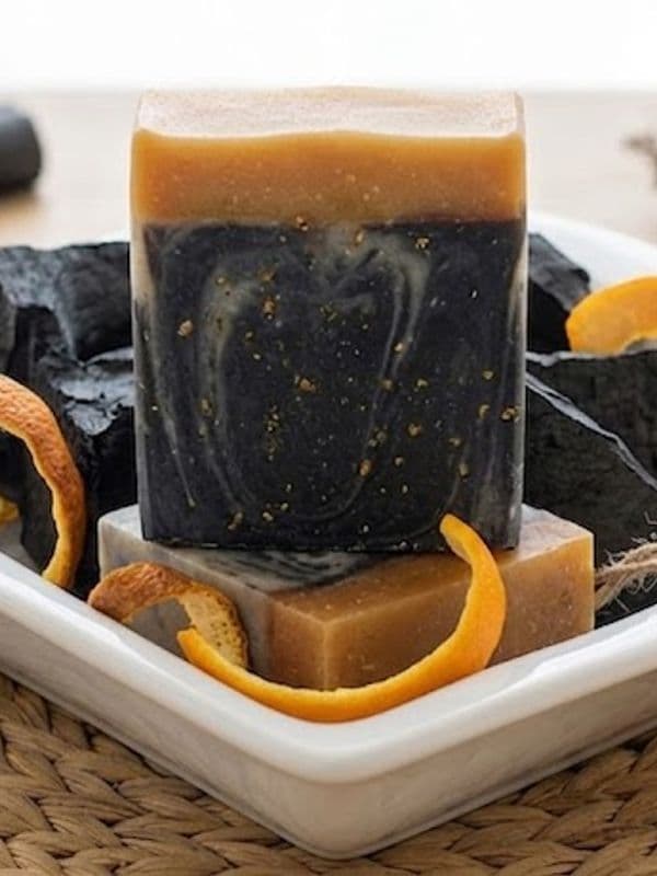 Charcoal and Orange peel Soap placed on bath Plate